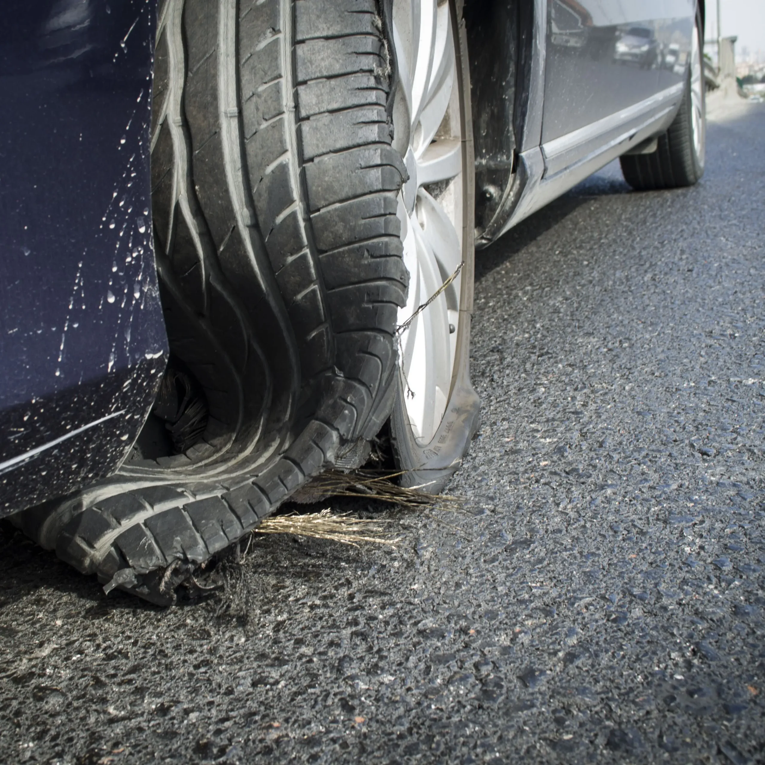 Damaged tire after tire explosion at high speed on highway stock photo