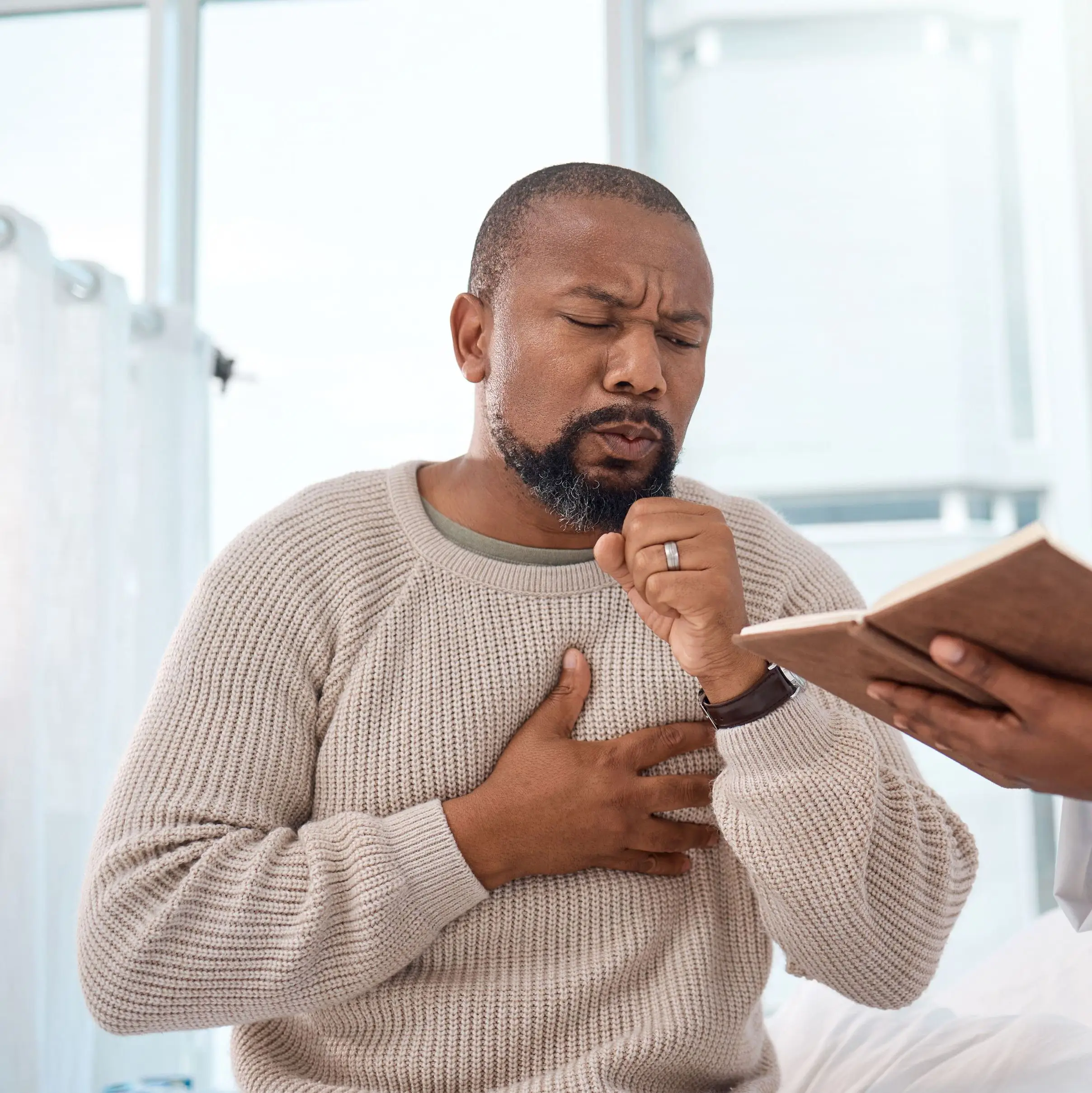Shot of a mature man coughing
