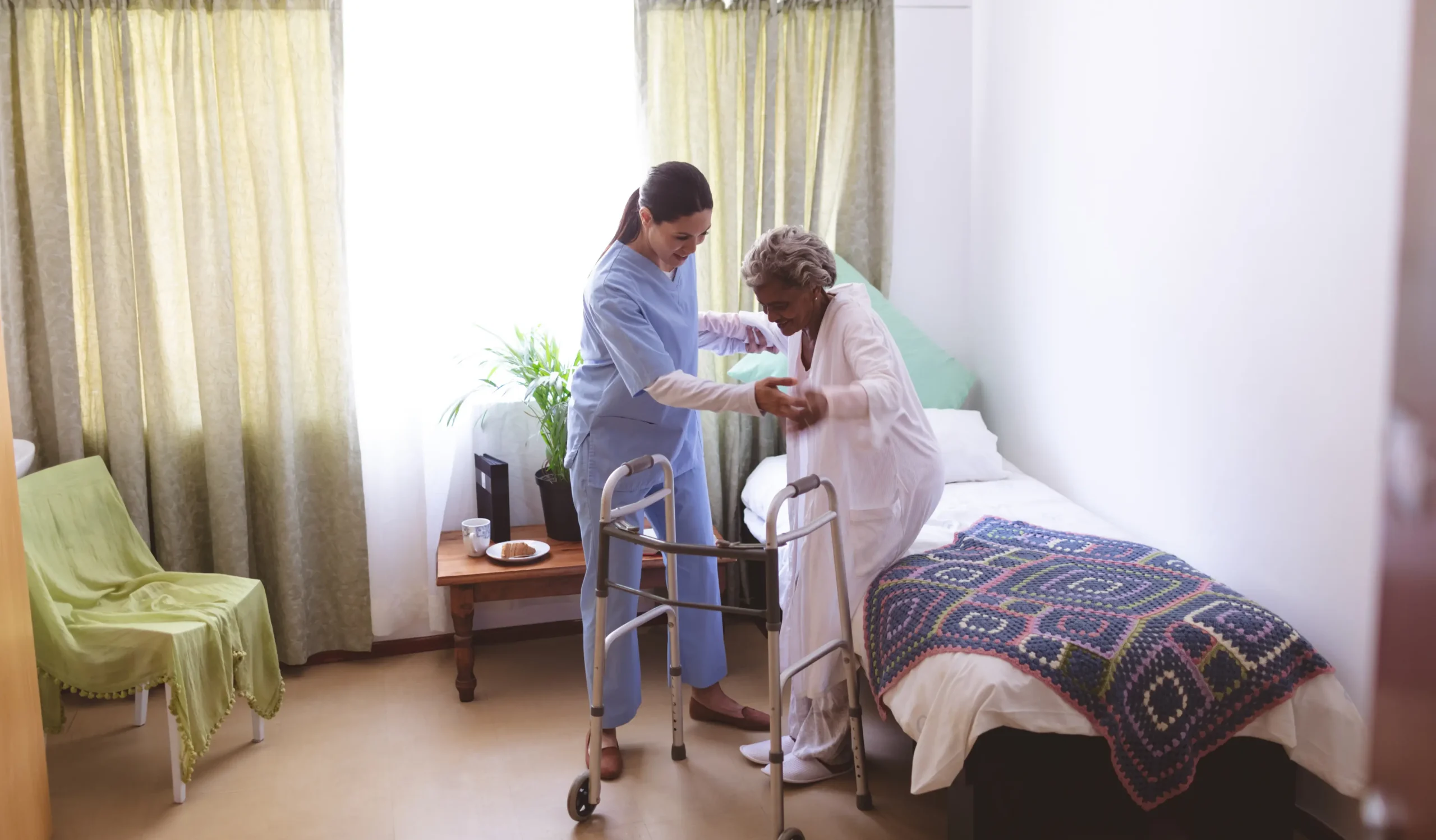 Female nurse helping senior female patient