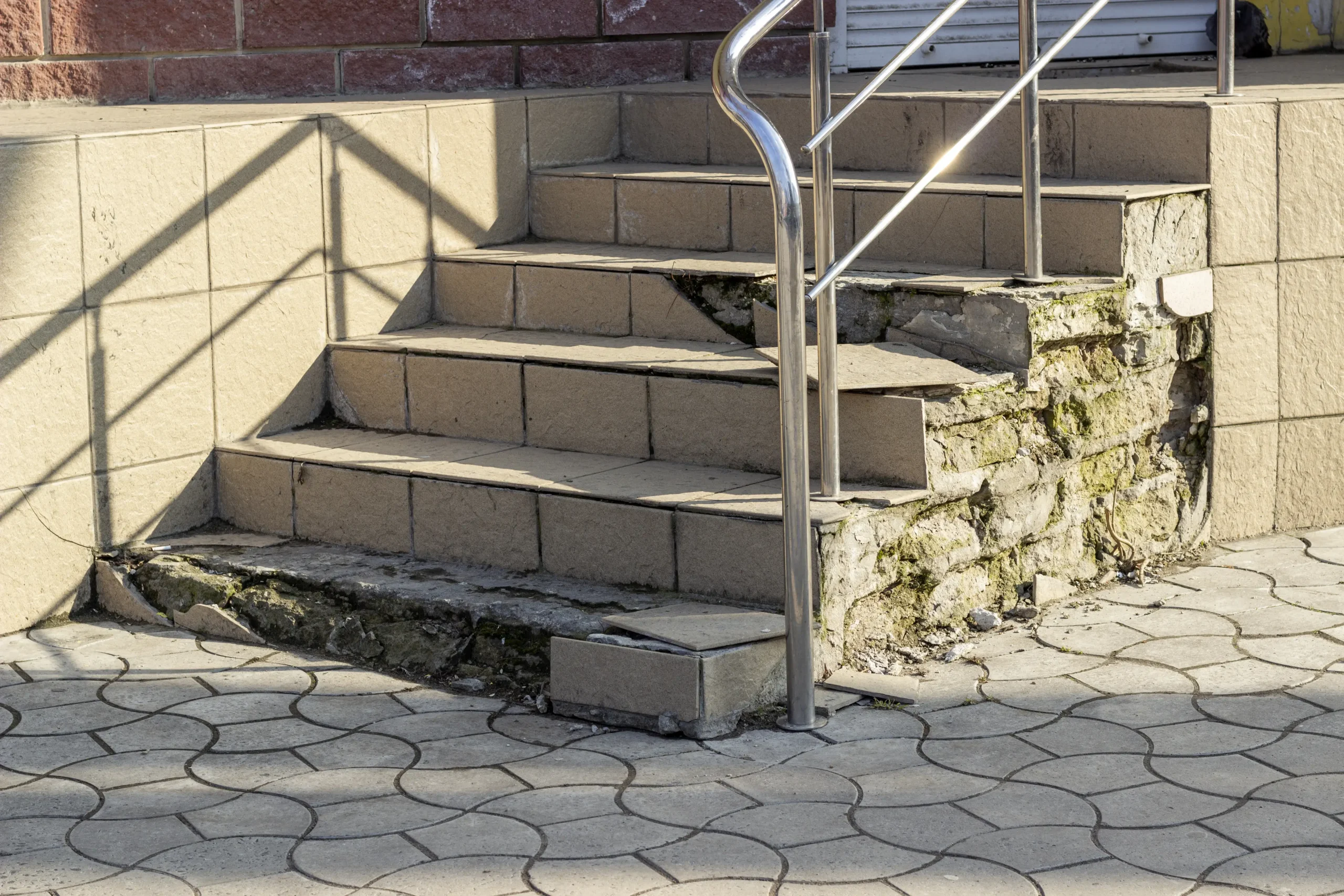 Old concrete stairs crumble from old age and poor repairs