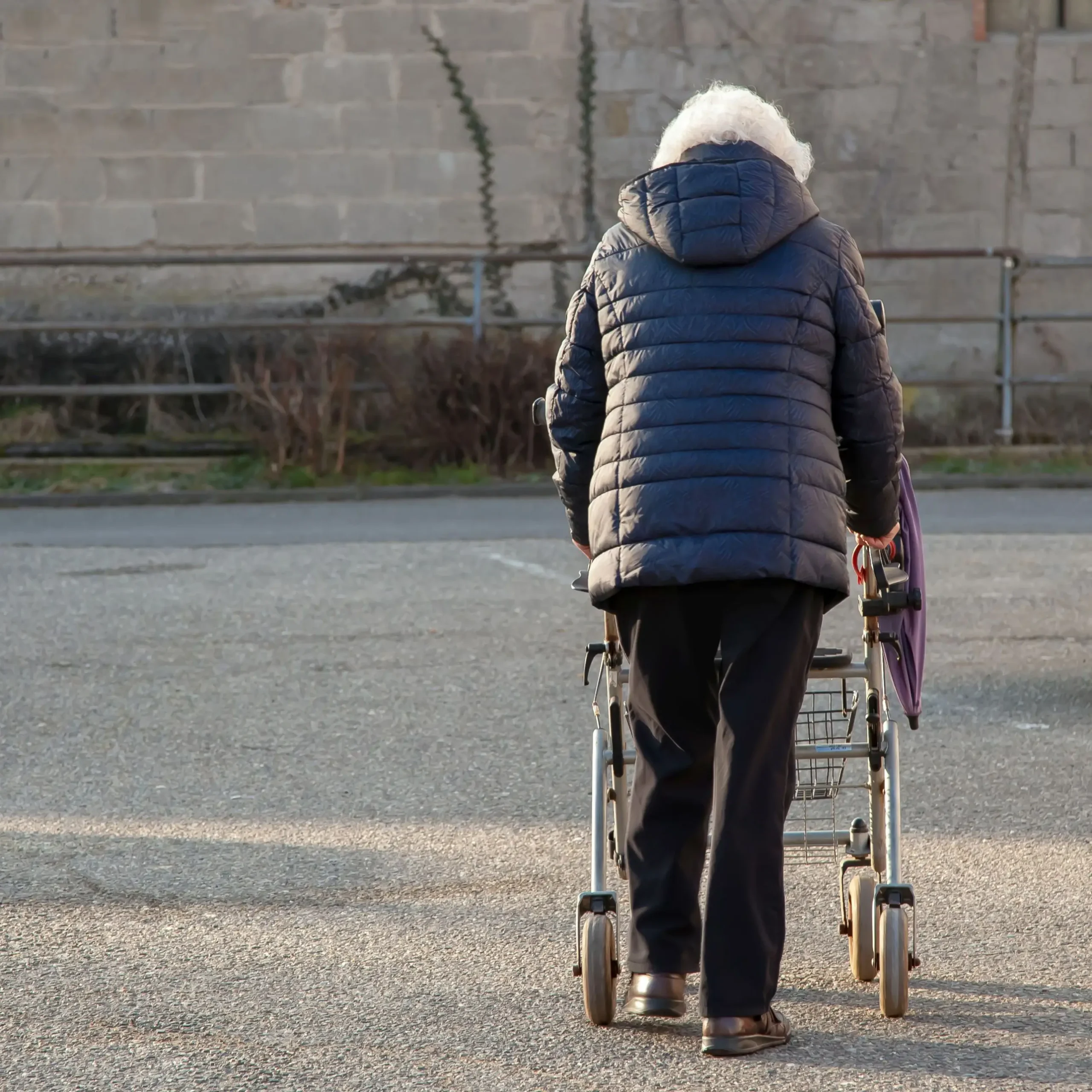 Senior woman walking alone parking lot