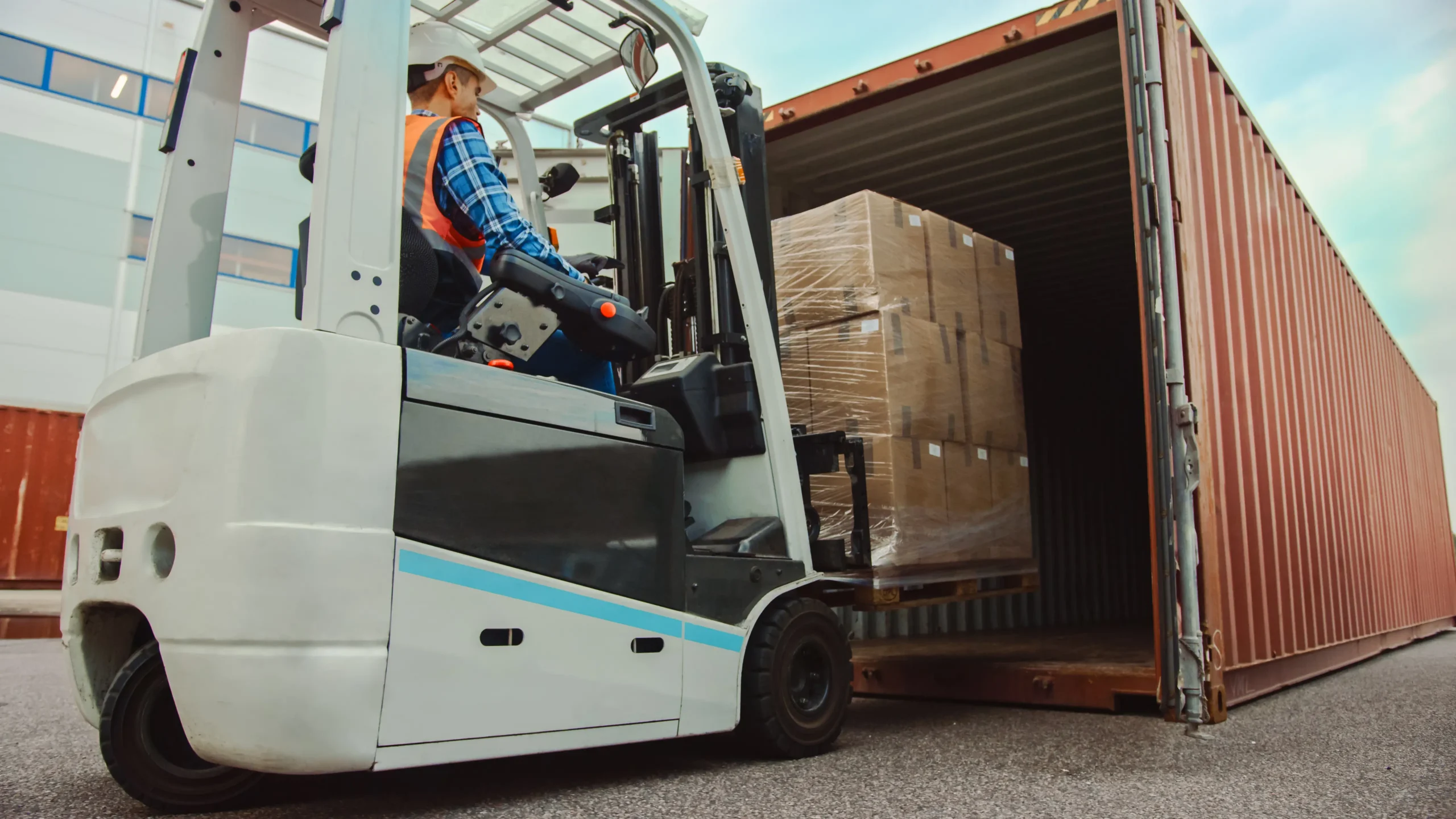 Forklift Driver Loading a Shipping Cargo Container