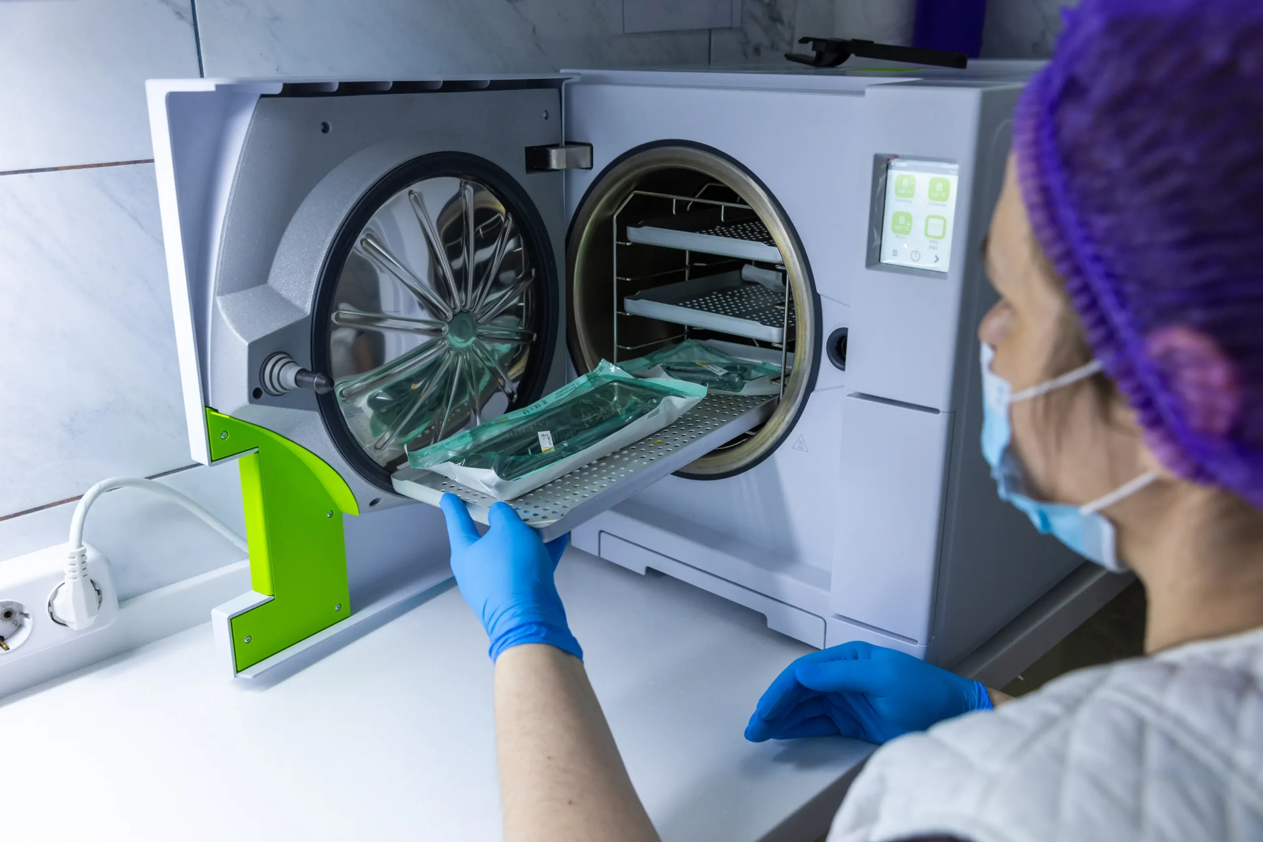A Healthcare Professional Using a Modern Autoclave for Sterilization