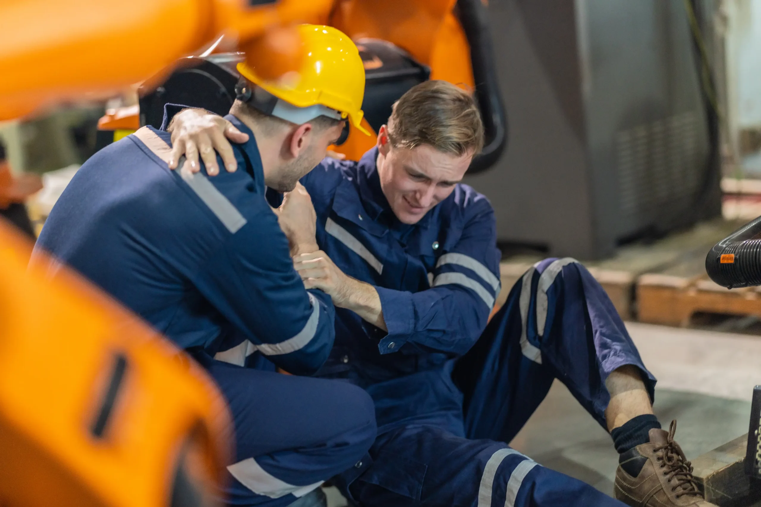 Factory Worker Helping Injured Colleague