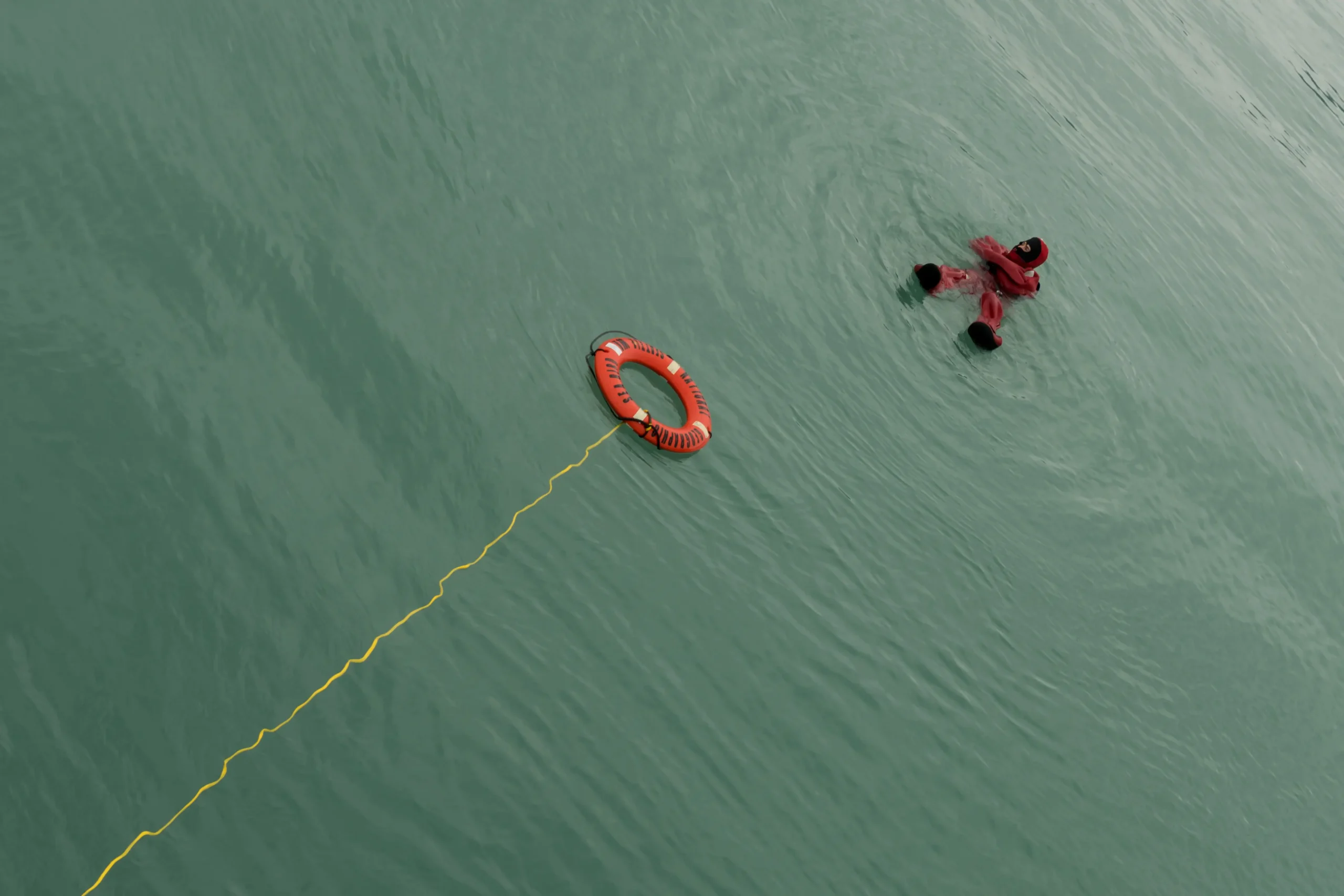 Ship crew member in the water
