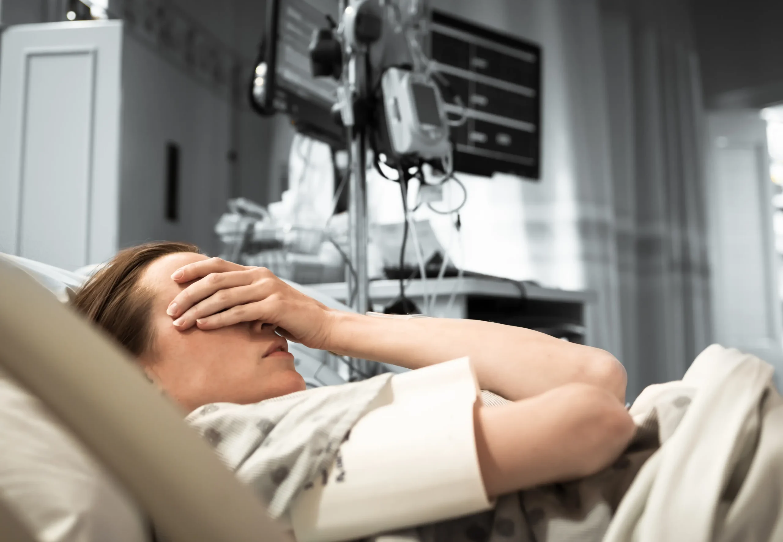 Young woman patient lying at hospital bed